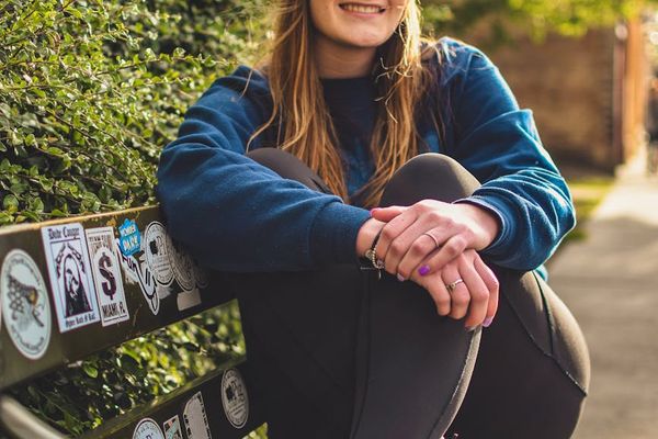 A person looking energized and happy in a natural park setting.